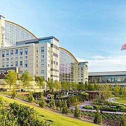 A large building with a green lawn.