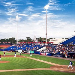 A baseball game in a stadium.