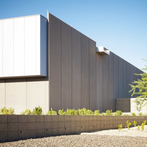 A grey building with a grey wall.