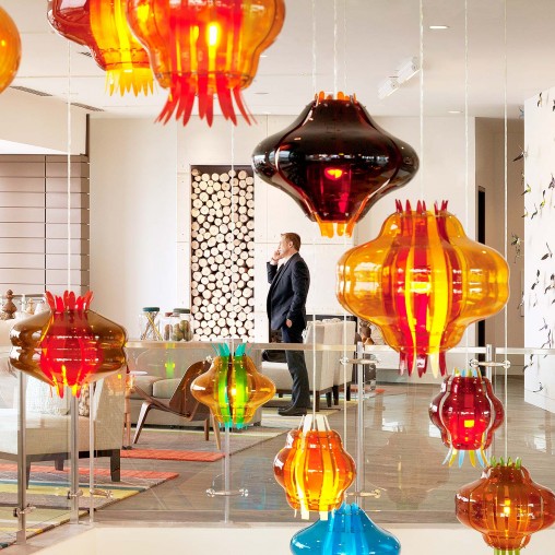 A person standing next to a display of vases.