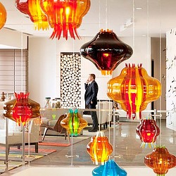 A person standing next to a display of vases.