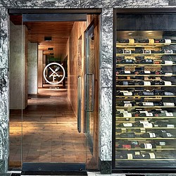 A room with shelves of wine.