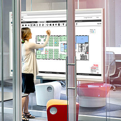 A person standing next to a machine.