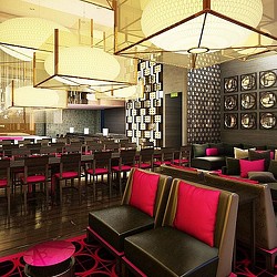 A room with a bar and chairs.