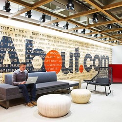 A person sitting on a couch with a laptop.