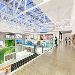 A large glass building with people walking around.