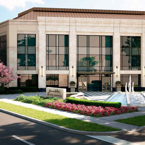 A building with a flower bed in front of it.
