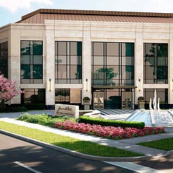 A building with a flower bed in front of it.