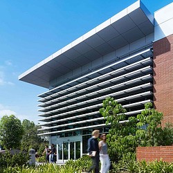 A couple of people standing in front of a building.