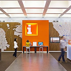A man and a woman looking at a display of computers.