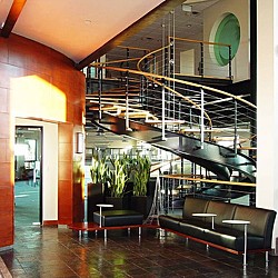 A room with a staircase and a glass wall.