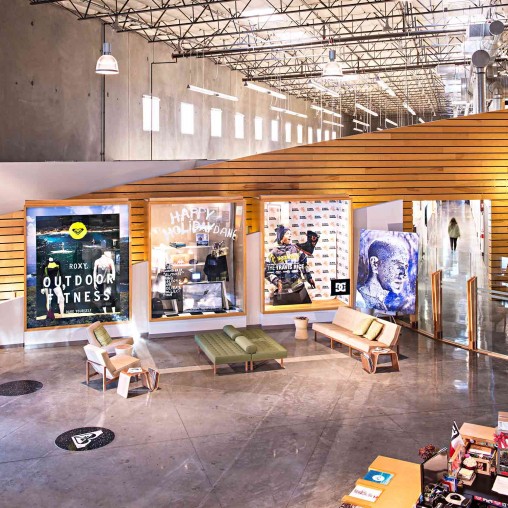 A room with benches and posters.