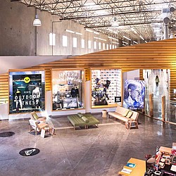 A room with benches and posters.