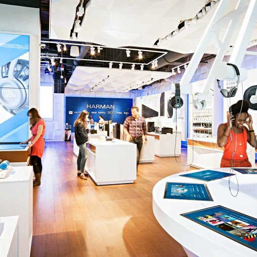 People in a room with a display.