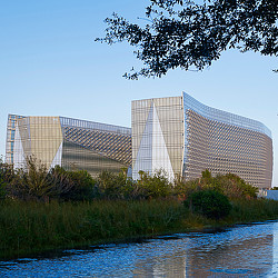 A building with a pond in front of it.