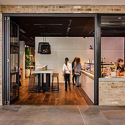 A couple of women walking into a store.