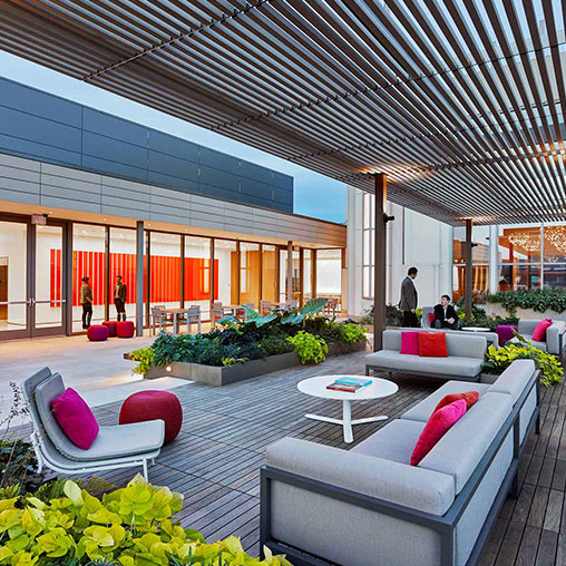 A modern looking building with a few people and a table.
