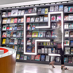 A person standing in front of a shelf of video games.
