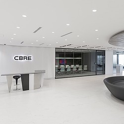 A large room with a glass front door and a large white wall.