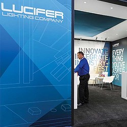 A man standing next to a sign.