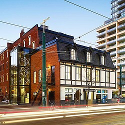 A building with a green pole.