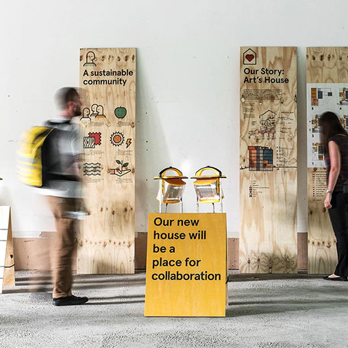 A man and woman looking at a sign.