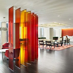 A room with red walls and a person sitting in a chair.
