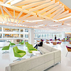 A room with a few people and tables.