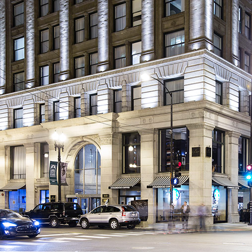 A building with cars parked in front.