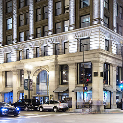 A building with cars parked in front.