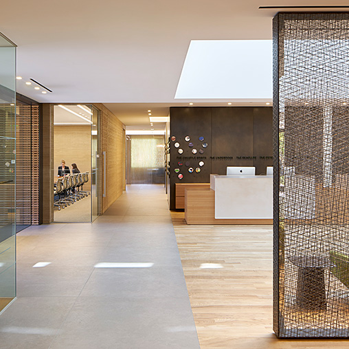 A large office building with a large glass door.
