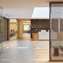 A large office building with a large glass door.