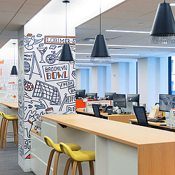 A room with a desk and chairs.