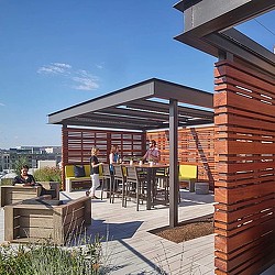 A group of people sitting at a table outside.