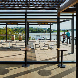 A patio with tables and chairs.