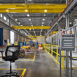 A large warehouse with yellow and black machines.