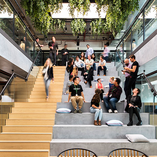 A group of people sitting on stairs.