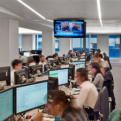 A group of people sitting at computers.