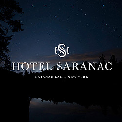 A body of water with trees and a starry sky above.