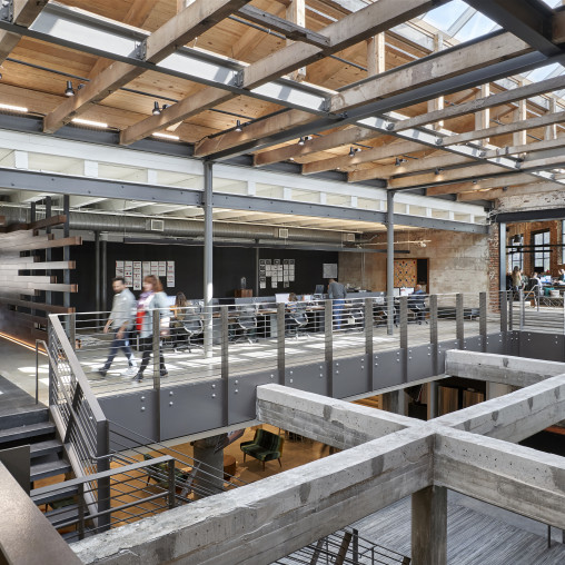 A couple of people walking in a large building.