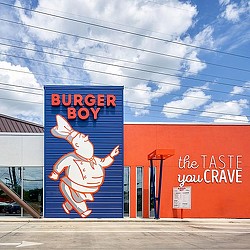 A large orange building with a cartoon character on it.