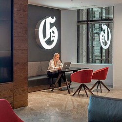A person sitting at a table with a laptop.