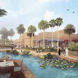 A pool with palm trees and a building in the background.