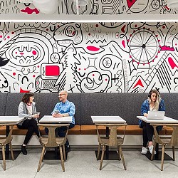 A group of people sitting at desks in a classroom.