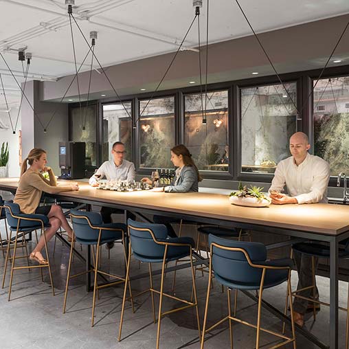 A group of people sitting at a table with food.