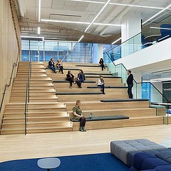 A group of people sitting on stairs.