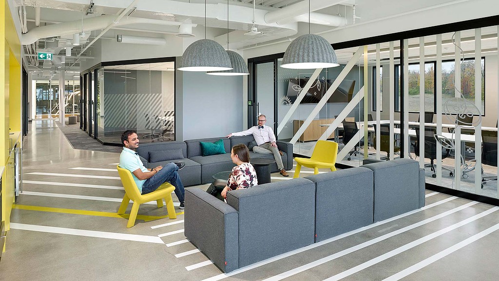 A man and a woman sitting on a couch in a room.