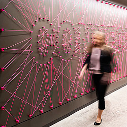 A person standing in front of a wall of lights.