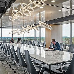 A large room with a table and chairs and a large chandelier.