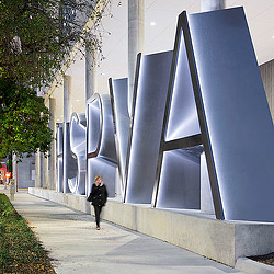 A man walking on a sidewalk.